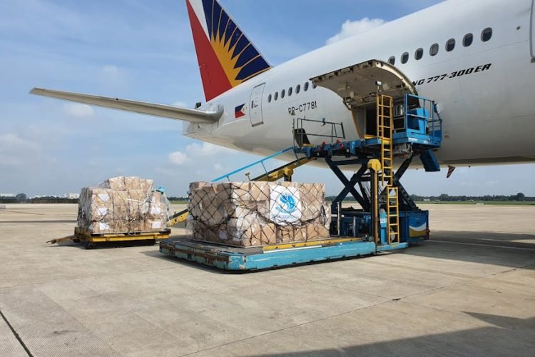 Cargo being loaded onto a commercial airplane at an airport in Ho Chi Minh City, Vietnam.
