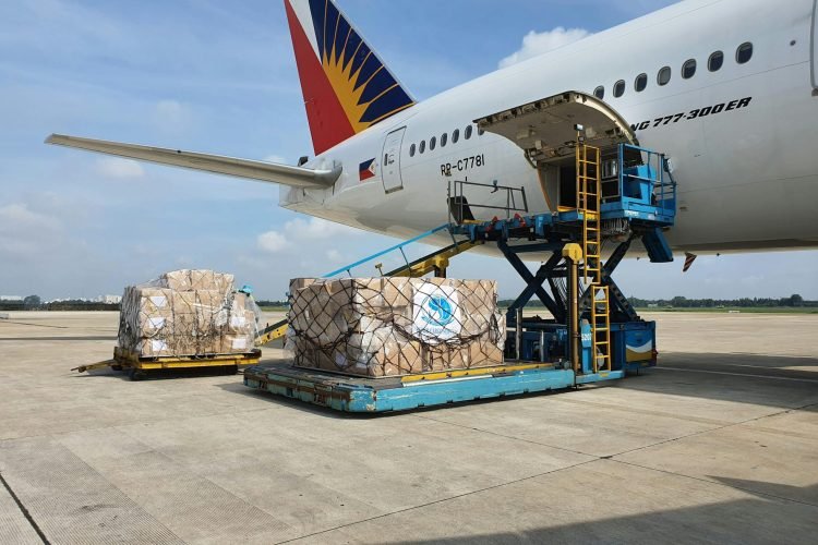 Cargo being loaded onto a commercial airplane at an airport in Ho Chi Minh City, Vietnam.